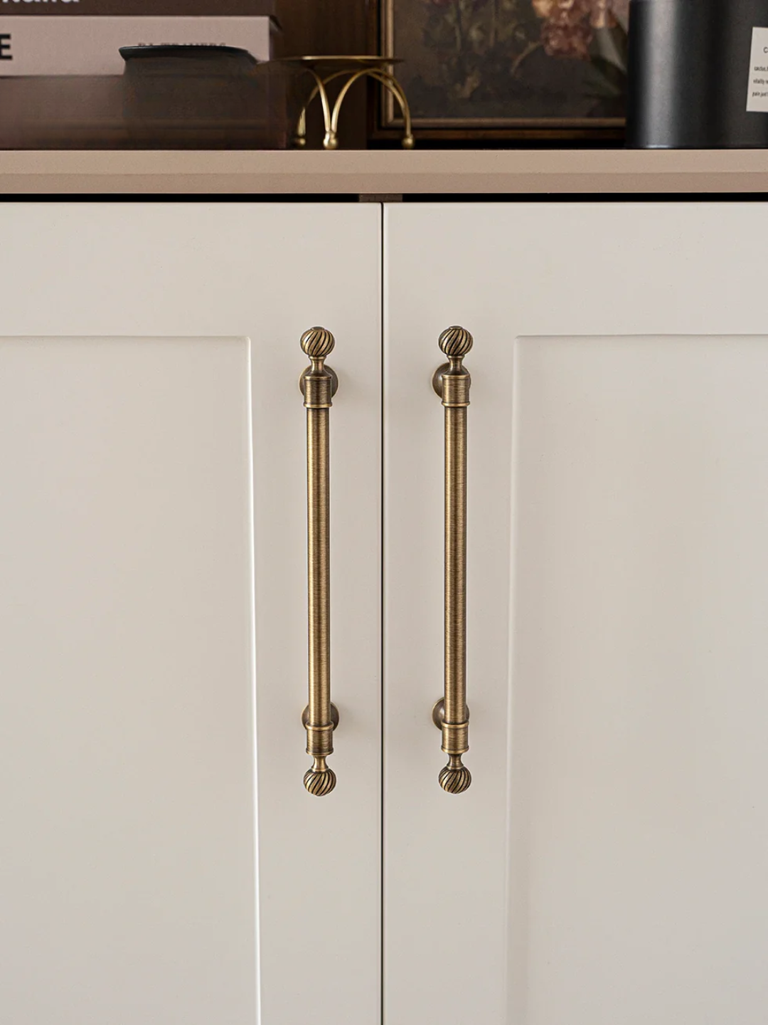 Cabinets with gold handles on a neutral background