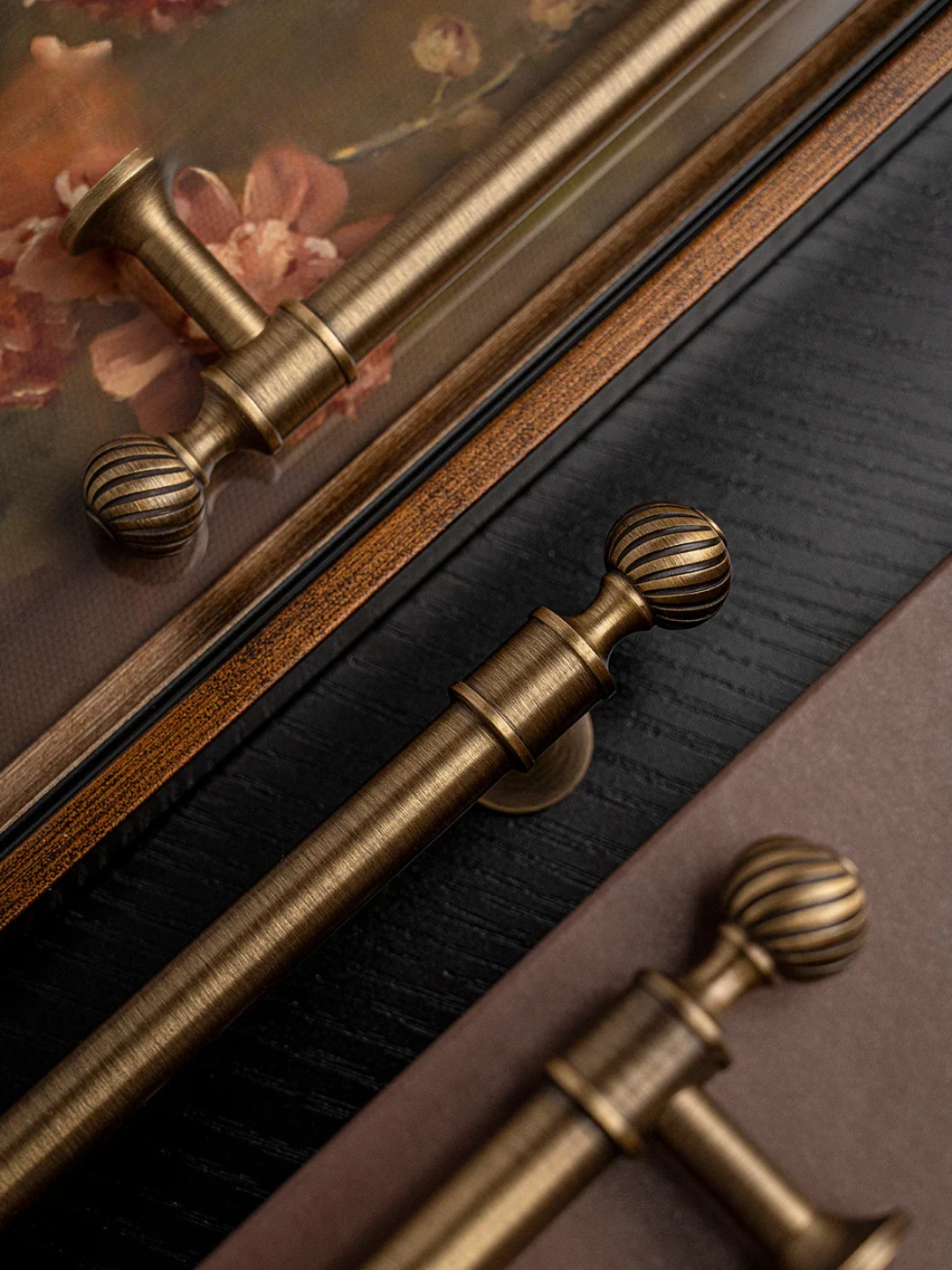 Set of gold cabinet handles and knobs on a brown surface with 'Callista' branding.