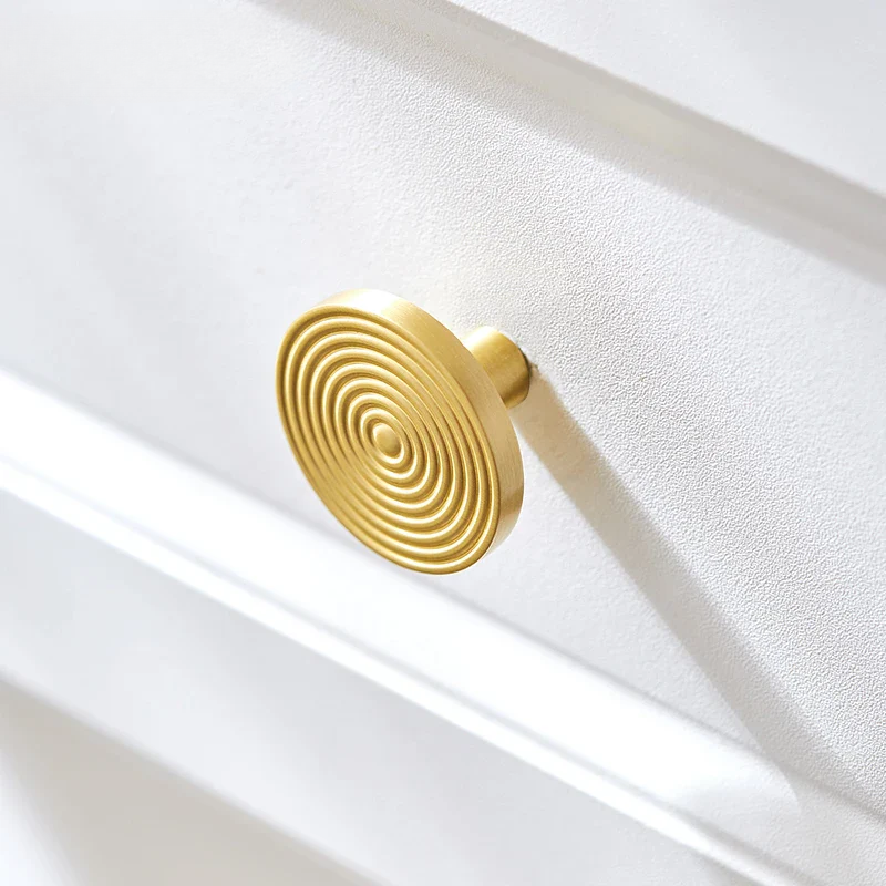Gold spiral design on a textured white surface