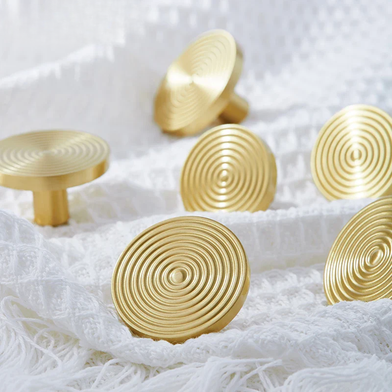 Gold spiral design handles on a white door