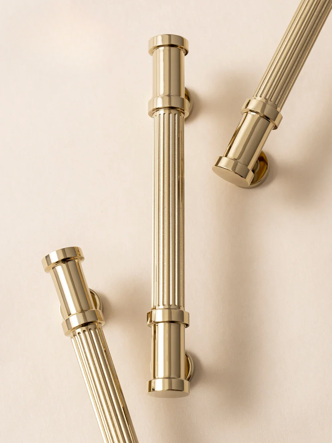 Gold towel racks on a beige background