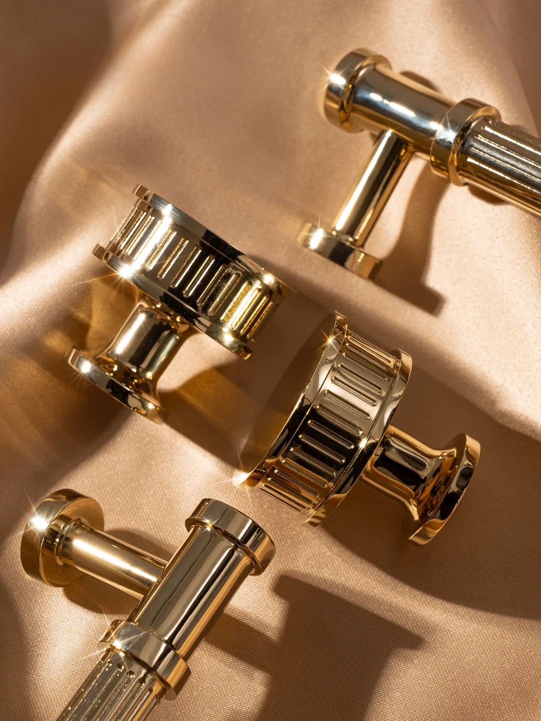 Gold cufflinks on a beige fabric background