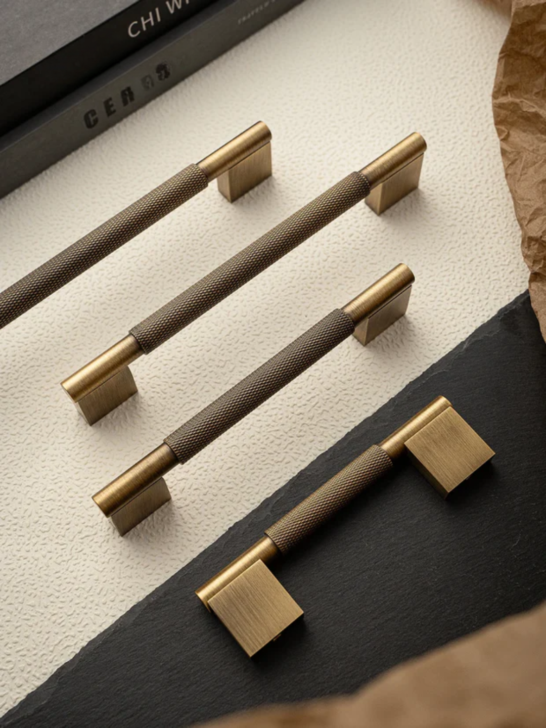 Set of five pens with bronze and black accents on a textured surface