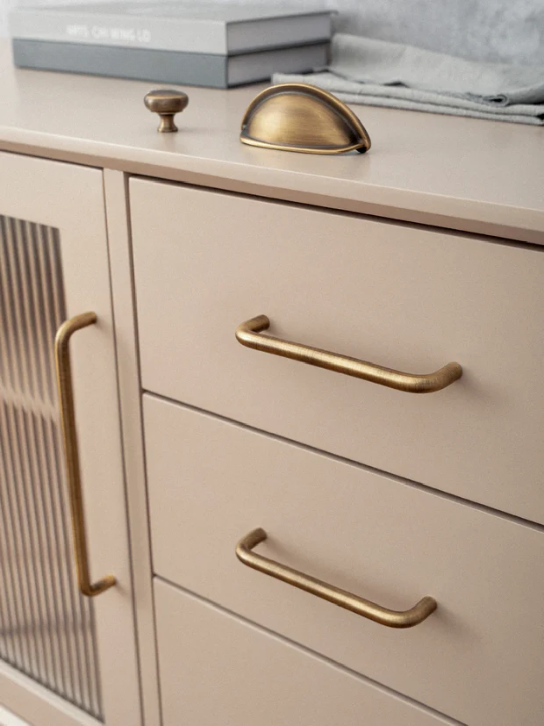 Set of gold cabinet handles and knobs on a gray surface with 'Santaya' branding.