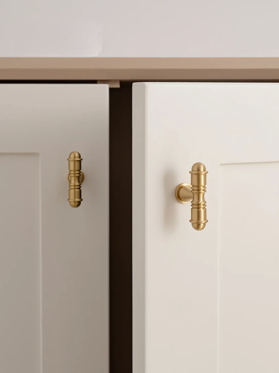Cabinets with gold handles on a white background, featuring the Santaya brand.