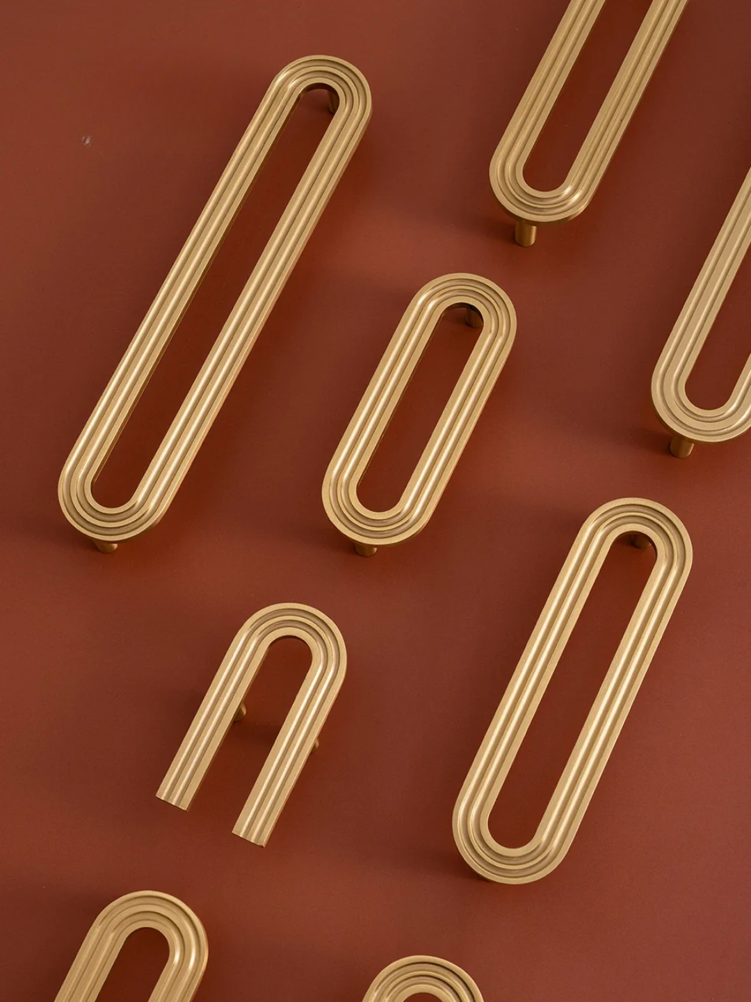 Gold paper clips on a red background