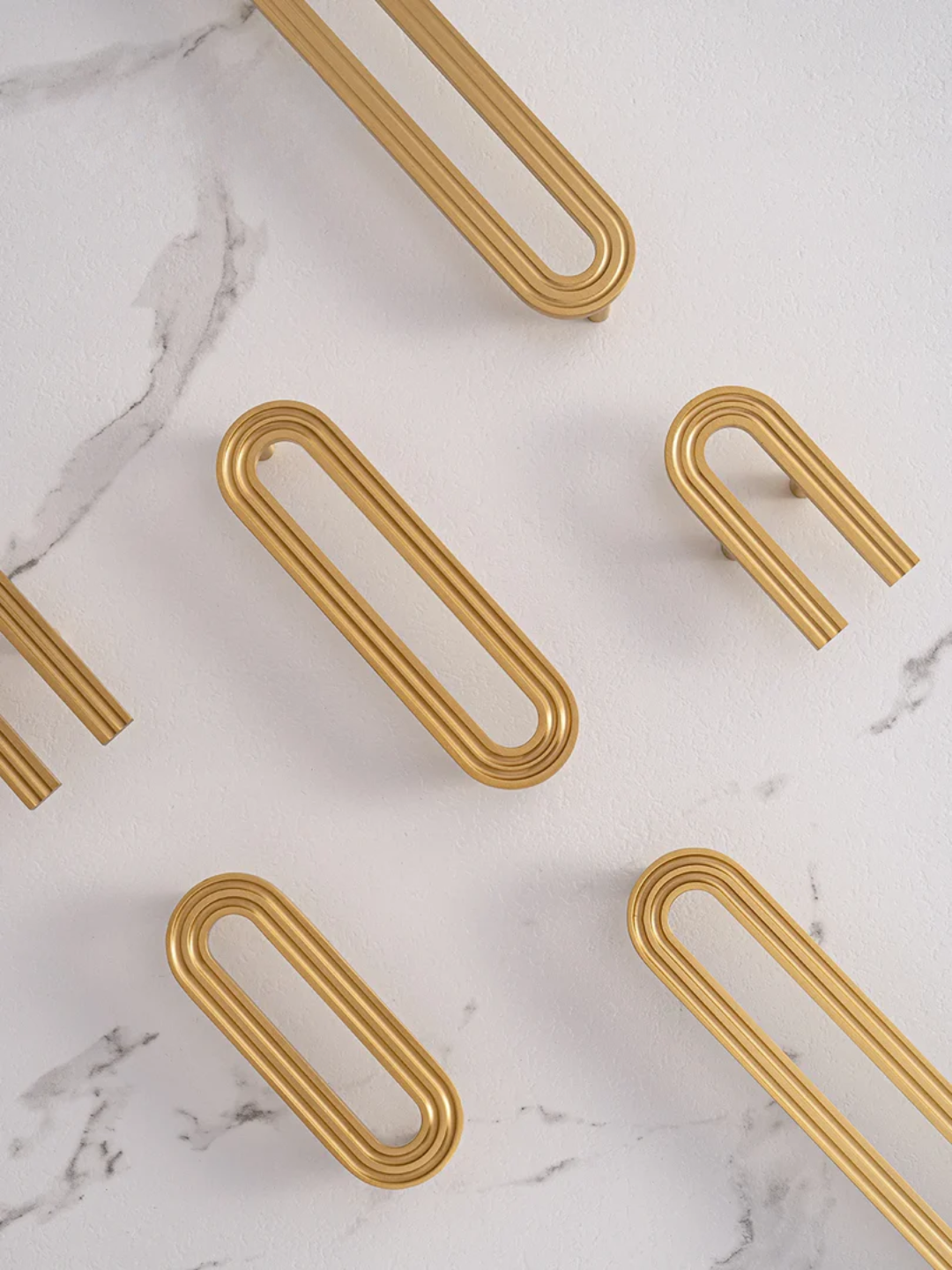 Gold paper clips on a marble surface
