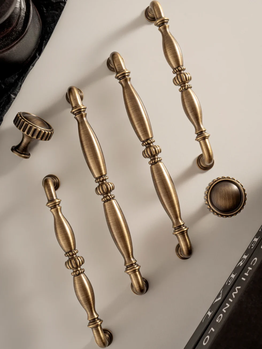 Set of bronze cabinet handles on a neutral background