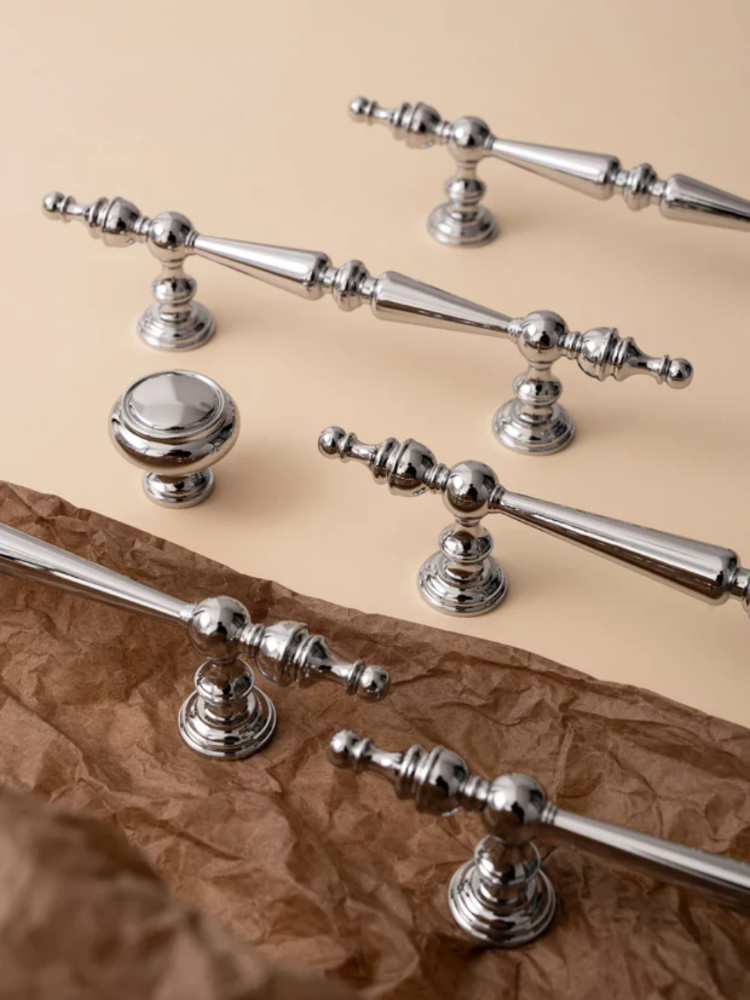 Set of silver door handles on a textured brown surface