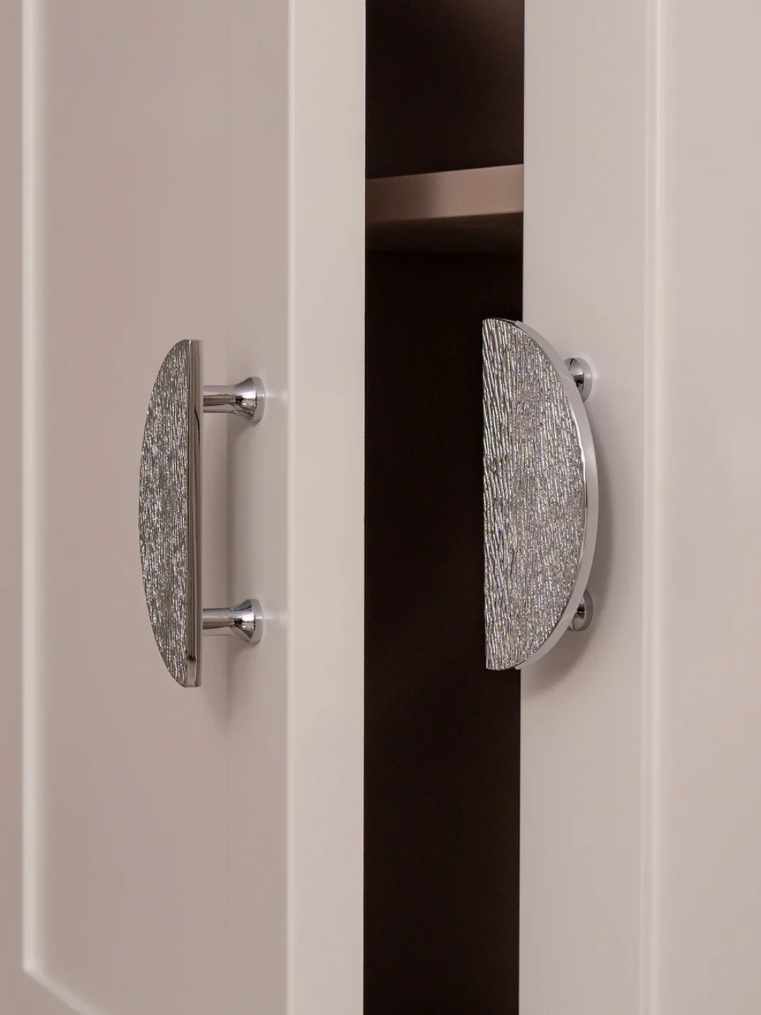 Close-up of a door with decorative handles on a neutral background