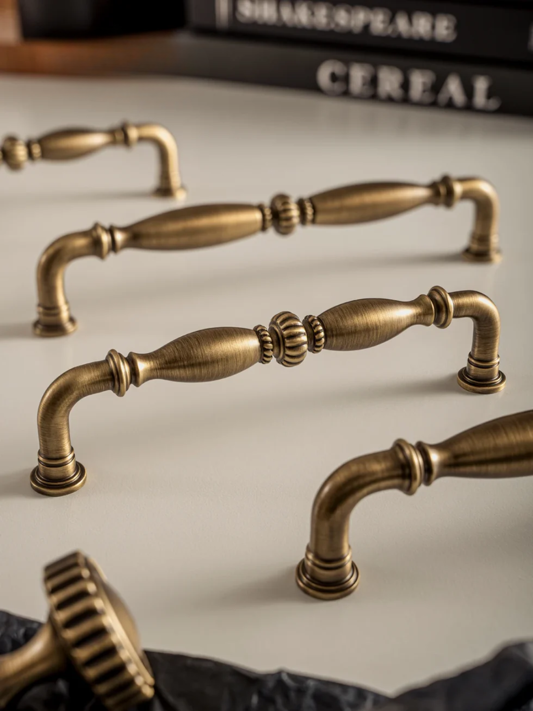Set of vintage-style brass cabinet handles on a neutral background