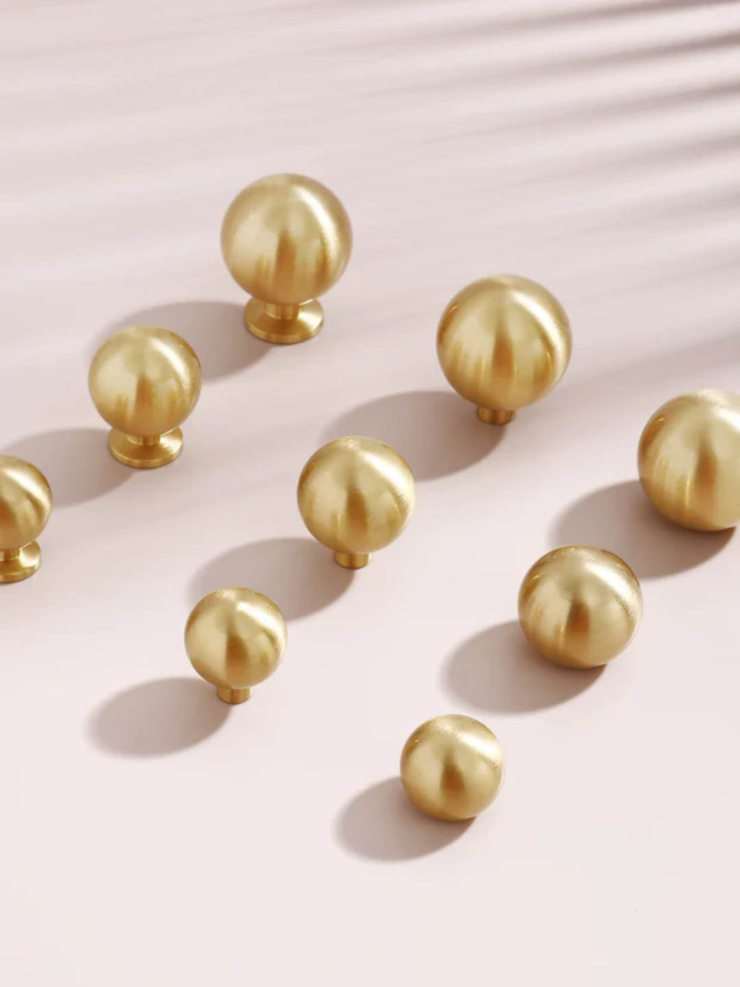 Gold spherical objects on a pink background