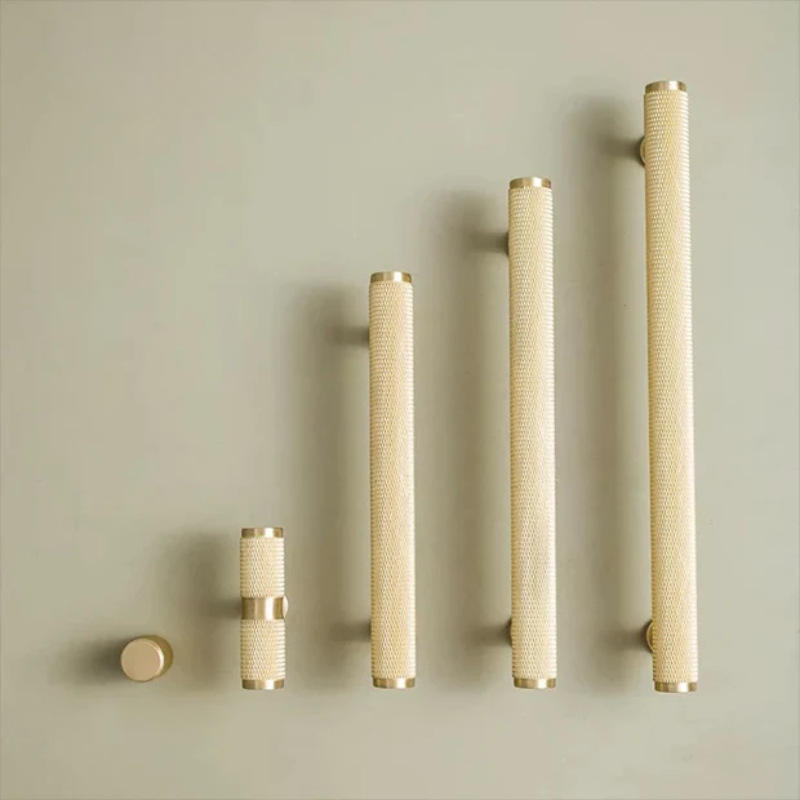 Set of cylindrical decorative elements with textured surface on a beige background