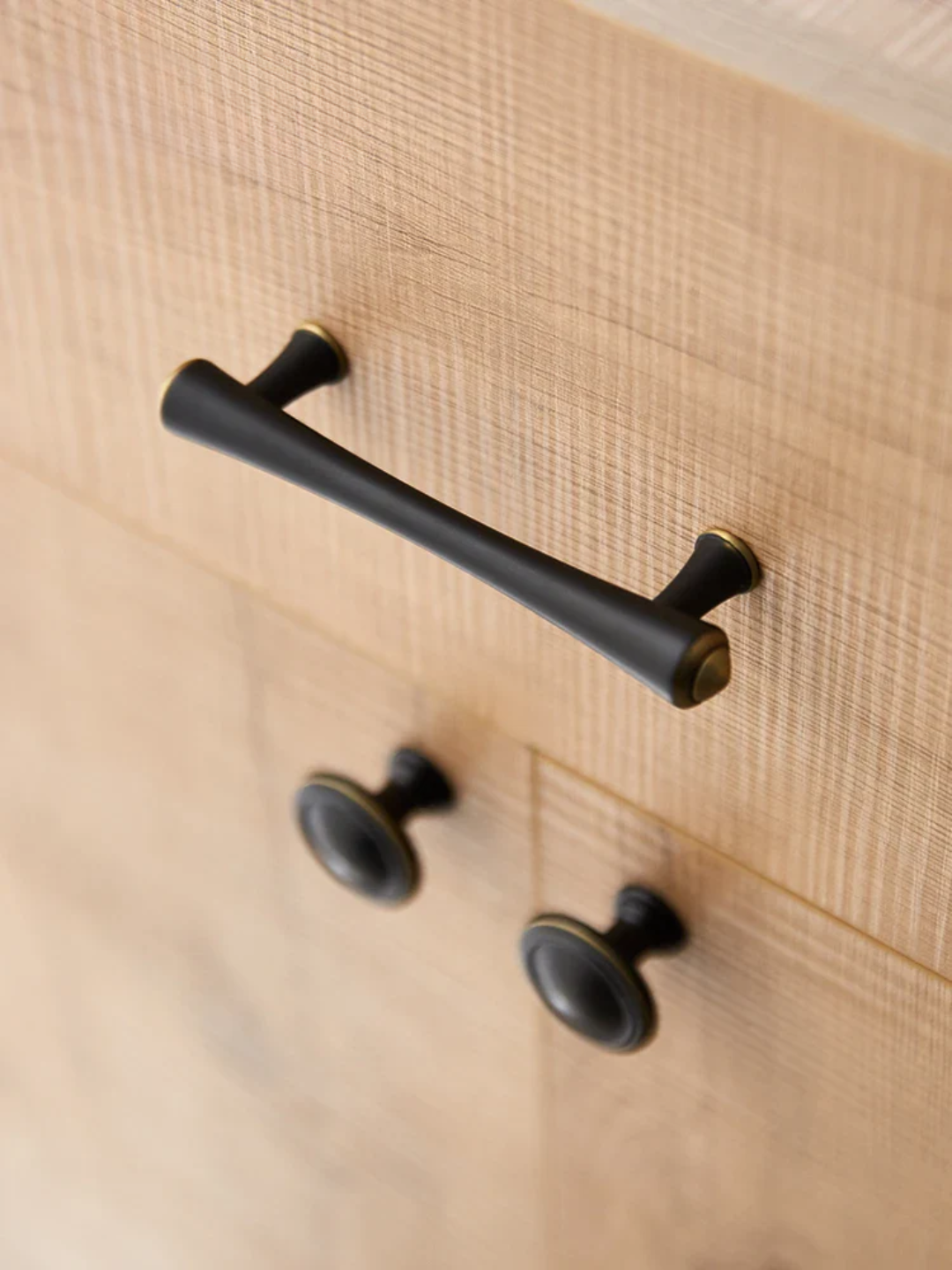 Black cabinet handle on a wooden door