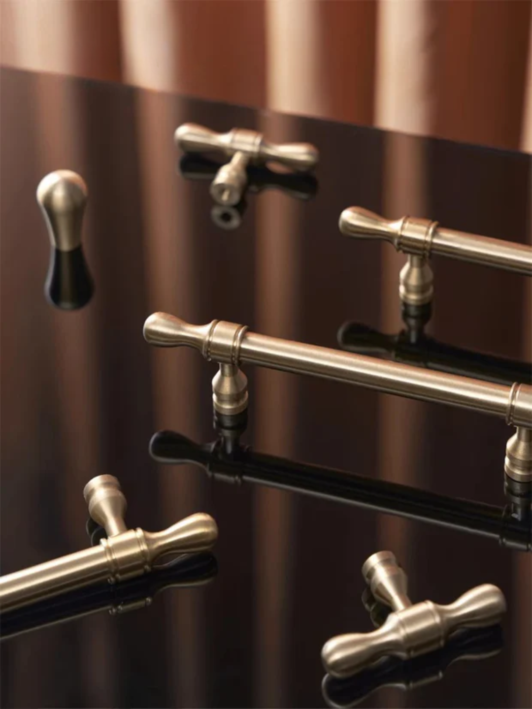 Metallic door handles on a wooden surface with 'Santaya' branding.