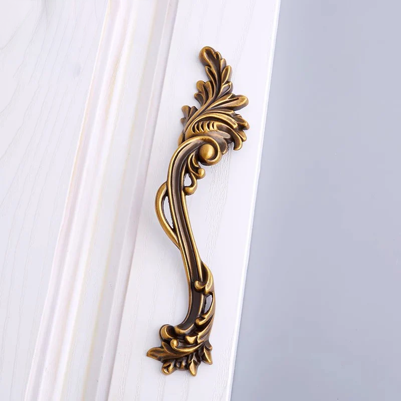 Decorative gold handle on a white background
