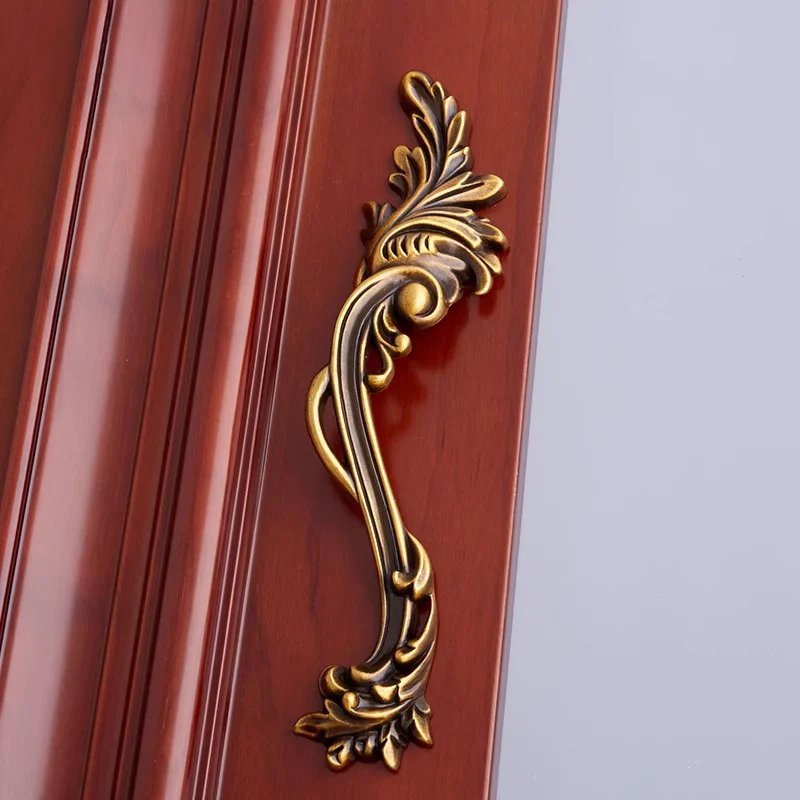 Decorative gold handle on a wooden door