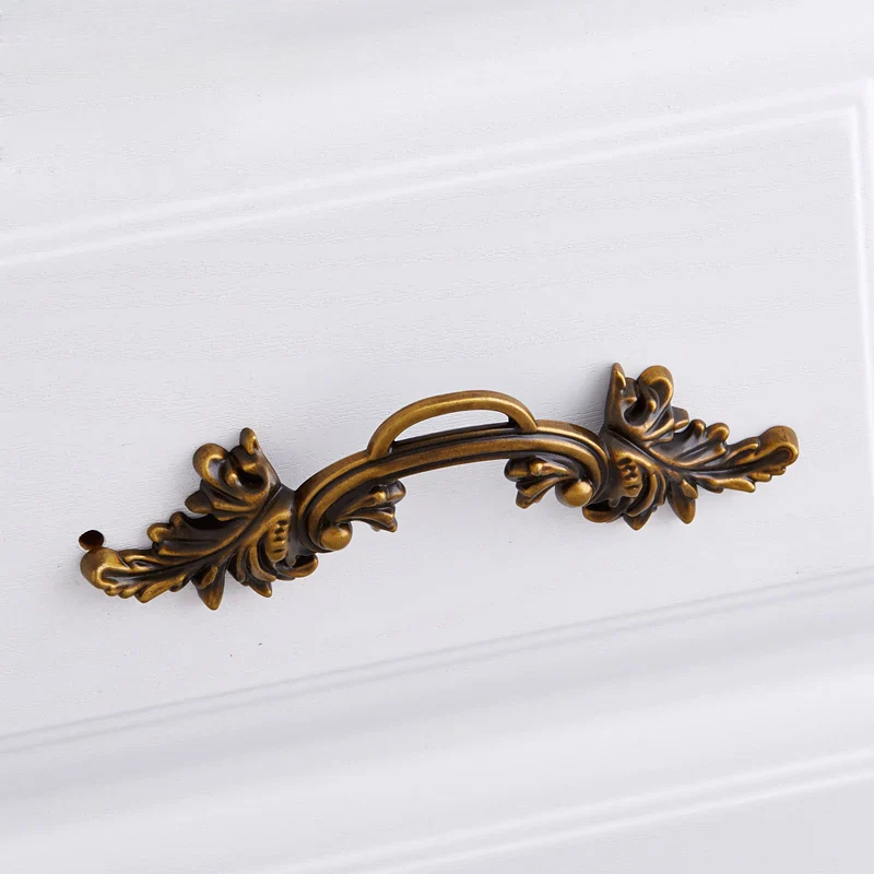 Decorative bronze handle on a white background