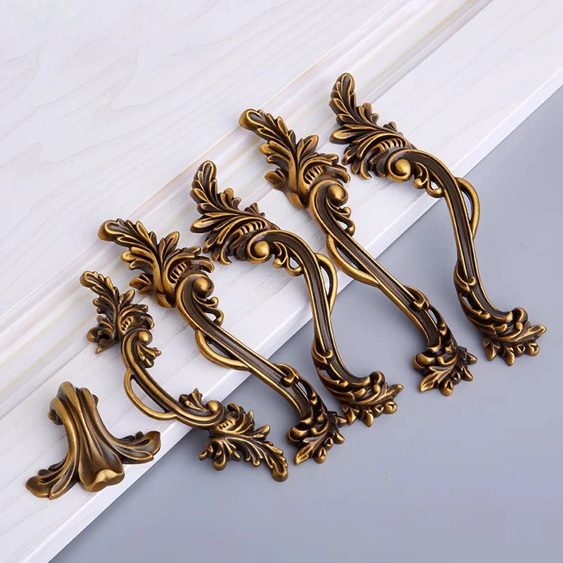 Decorative bronze handles on a white and gray background
