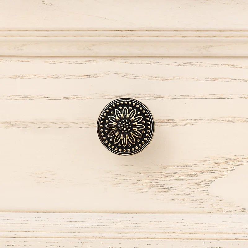 Decorative circular emblem with floral design on a wooden surface