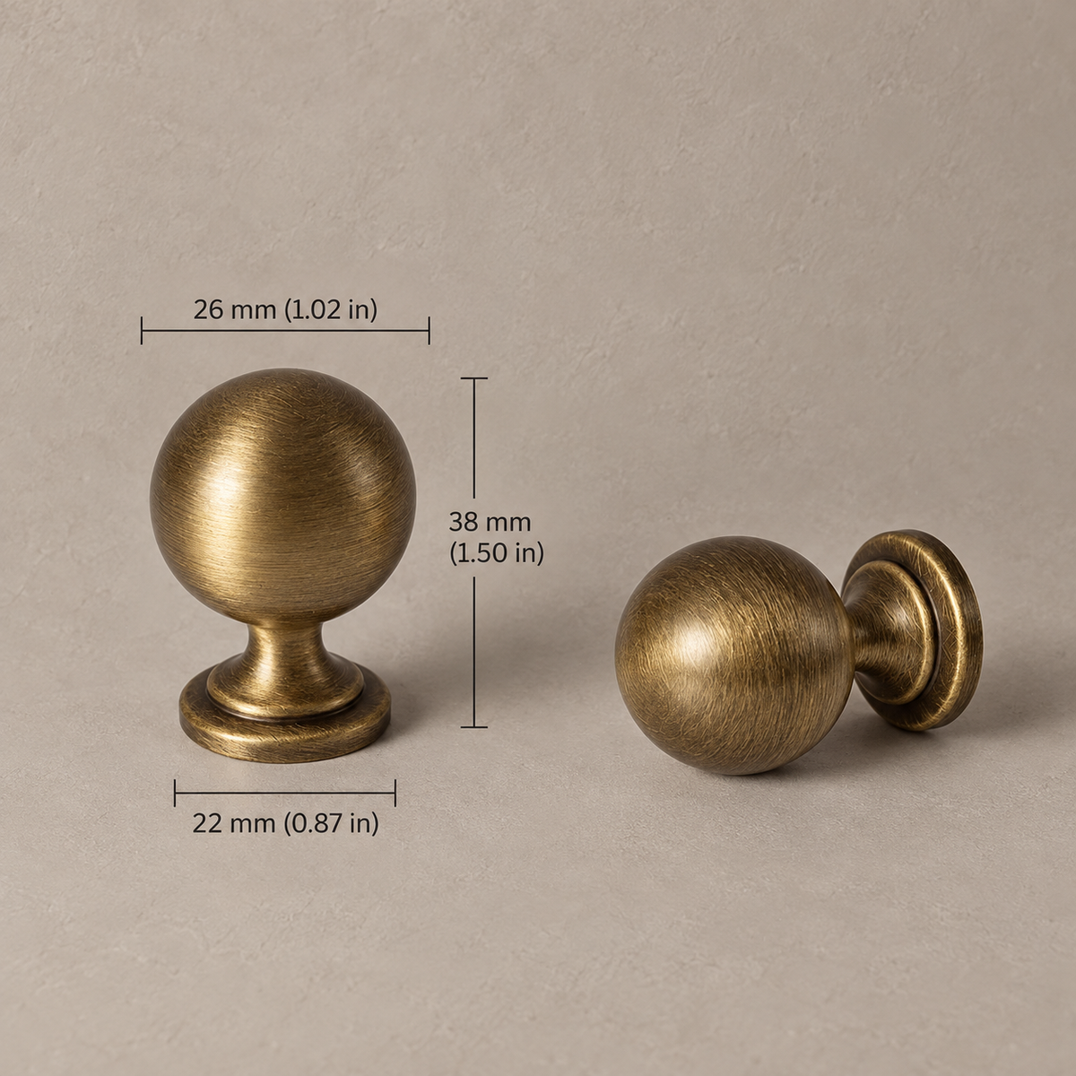 Antique brass classic vintage 26mm knob on taupe plaster, measurements in mm and inches
