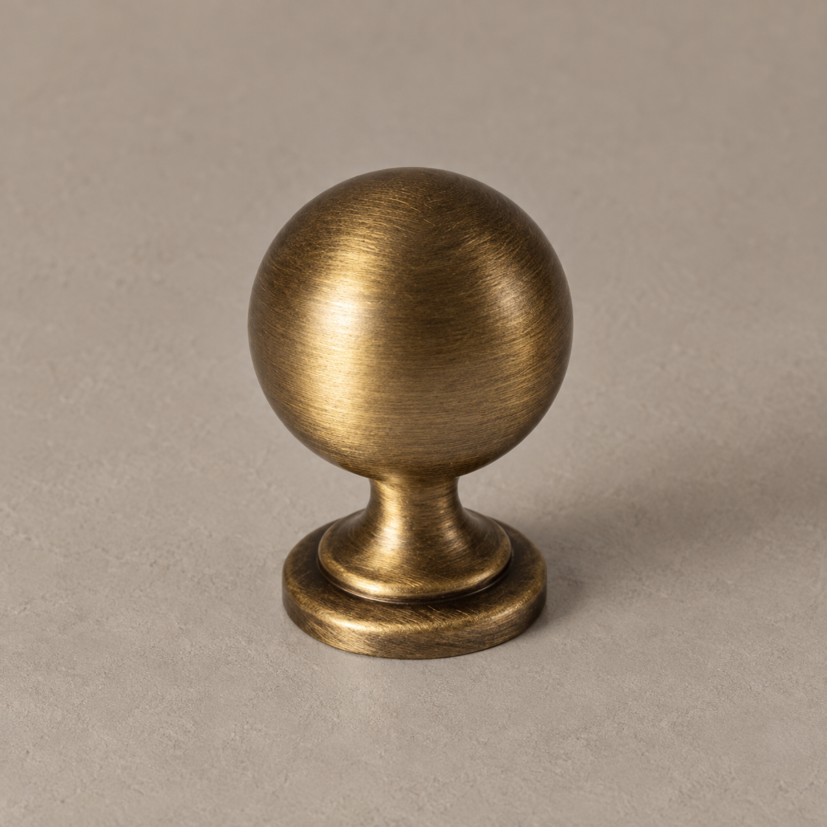 Antique brass classic vintage ball knob detail on taupe plaster