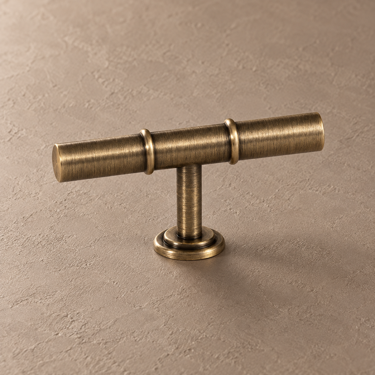 Antique brass cabinet hardware t bar detail on taupe plaster