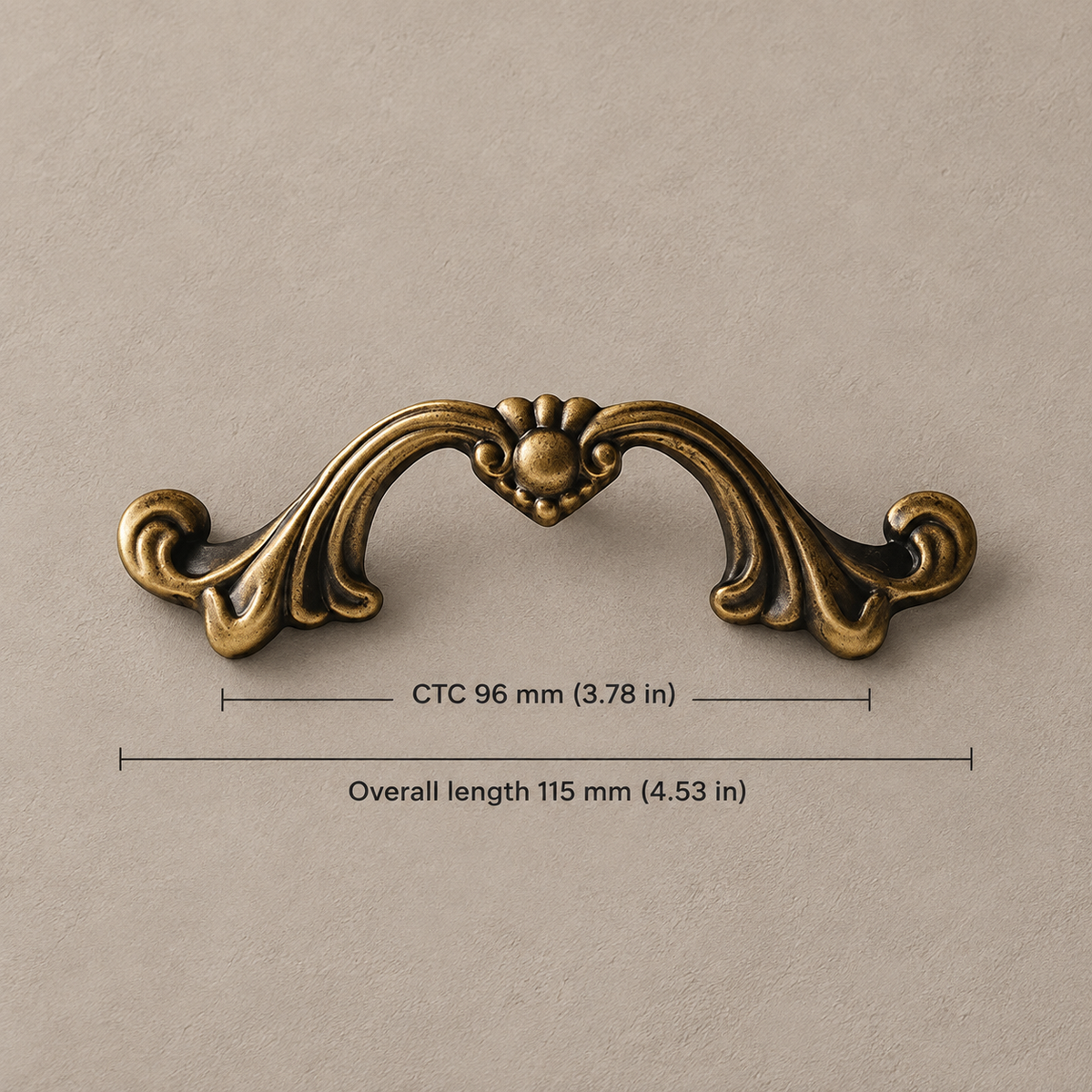 Antique brass scroll cabinet pull, 96 mm center-to-center and 115 mm overall, with inch equivalents