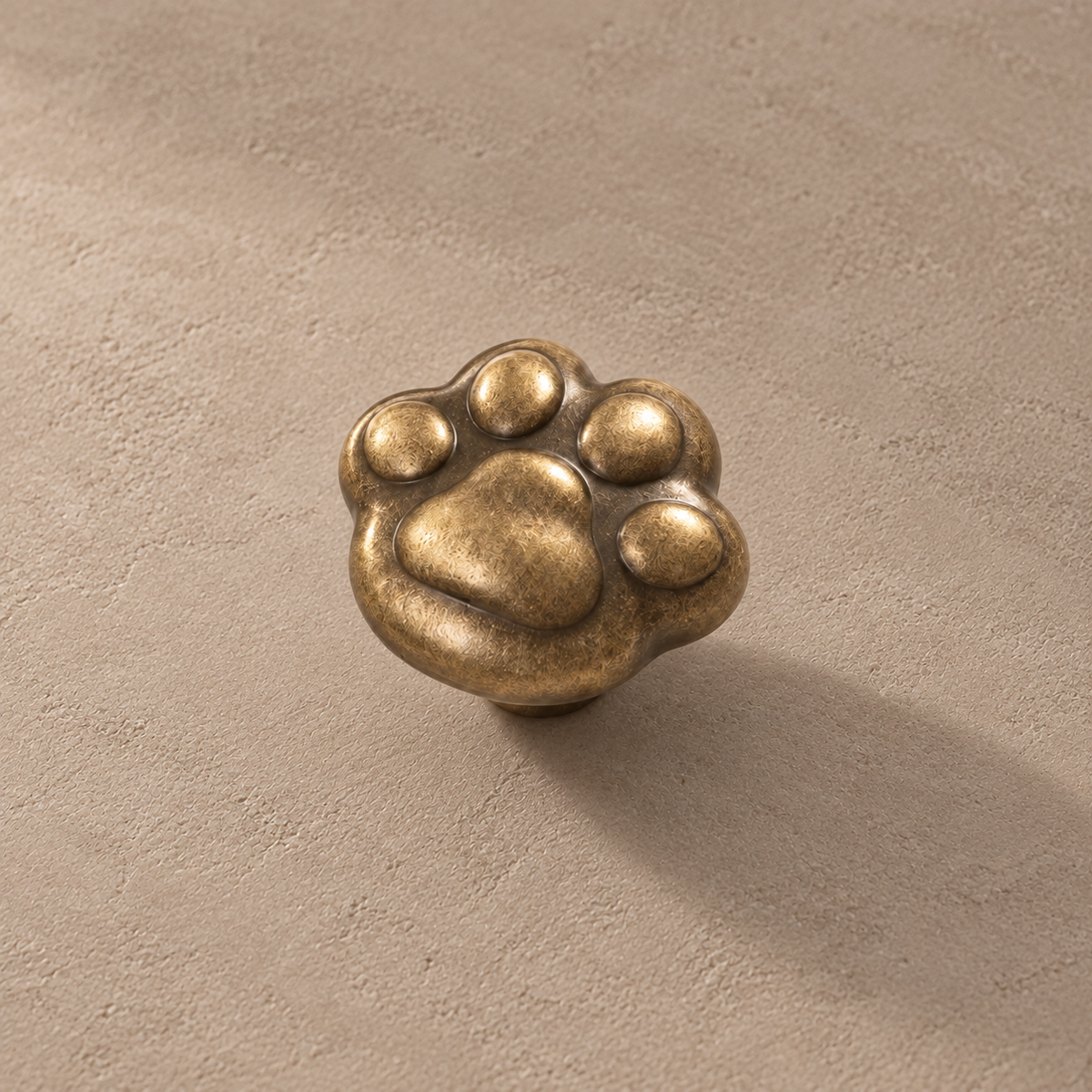 Detail view of antique brass paw knob and textured finish