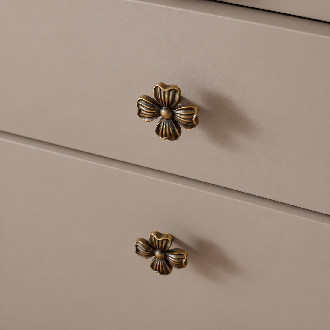 Antique Brass Petal-Design Solid Brass Cabinet Knob on a neutral stone studio background