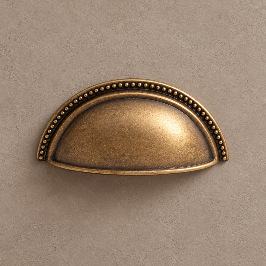 Antique Brass Shell-Shaped Thumb Cabinet Pull — Modern Design on a neutral stone studio background