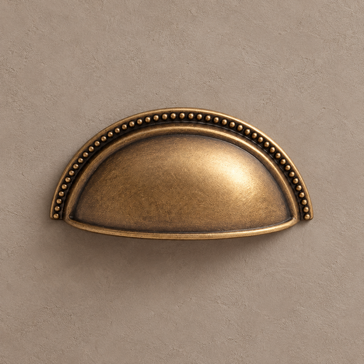 Antique brass shell cup pull beaded cup detail on taupe plaster