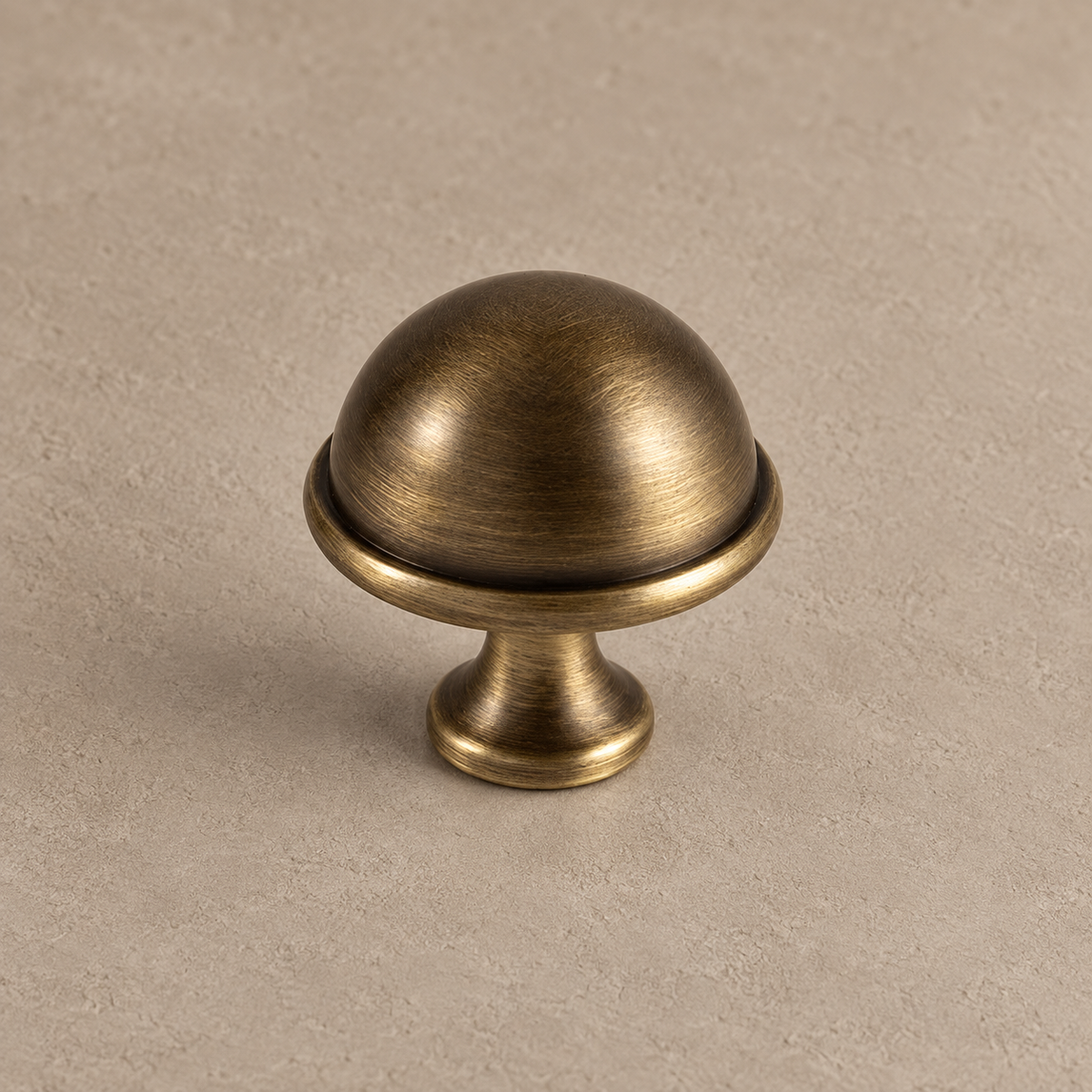 Antique brass slim bar dome knob detail on taupe plaster