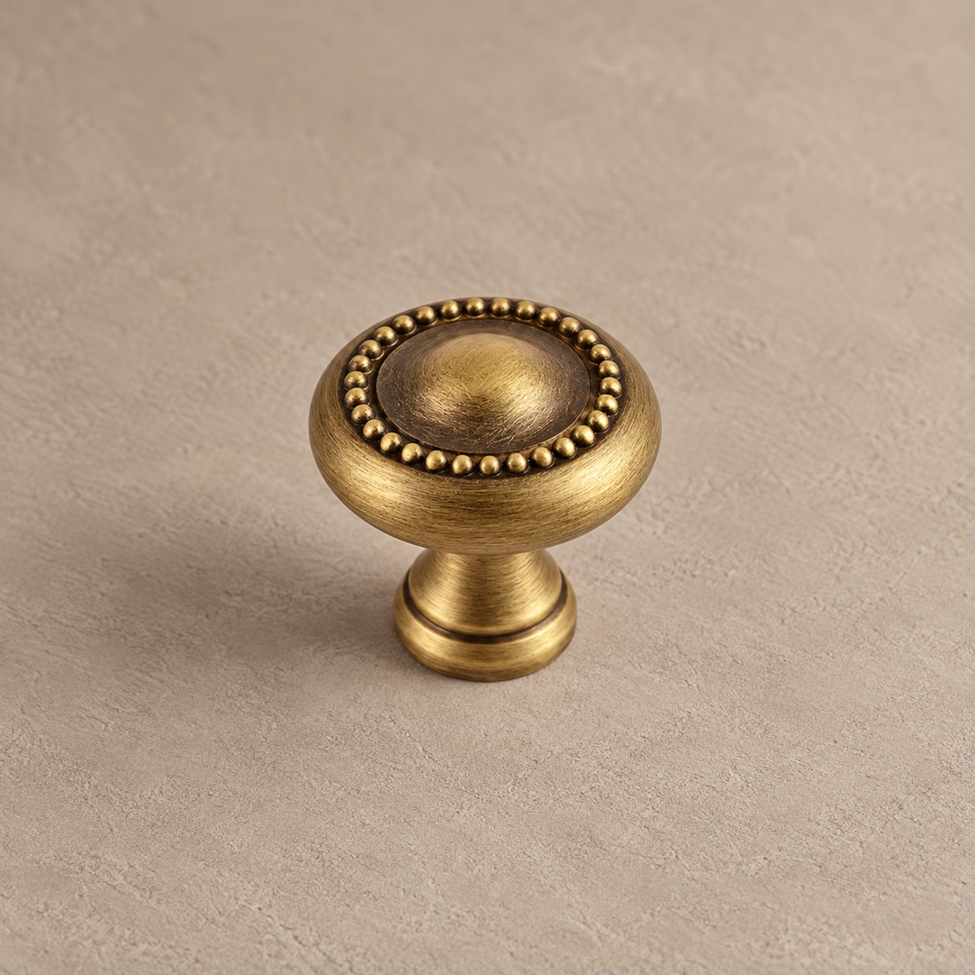Antique Brass Solid Brass Cabinet Pulls & Knobs — Crown Design on warm ivory stone