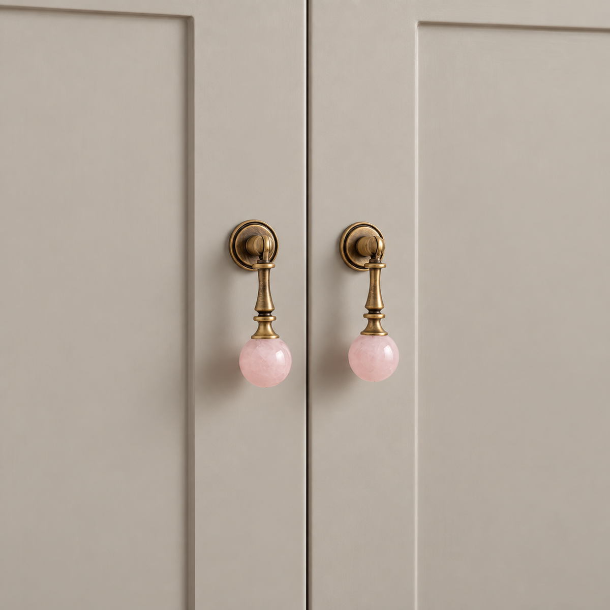 Antique Brass Drop Pulls with Stone & Wood Inlays — pink-stone-installed-detail