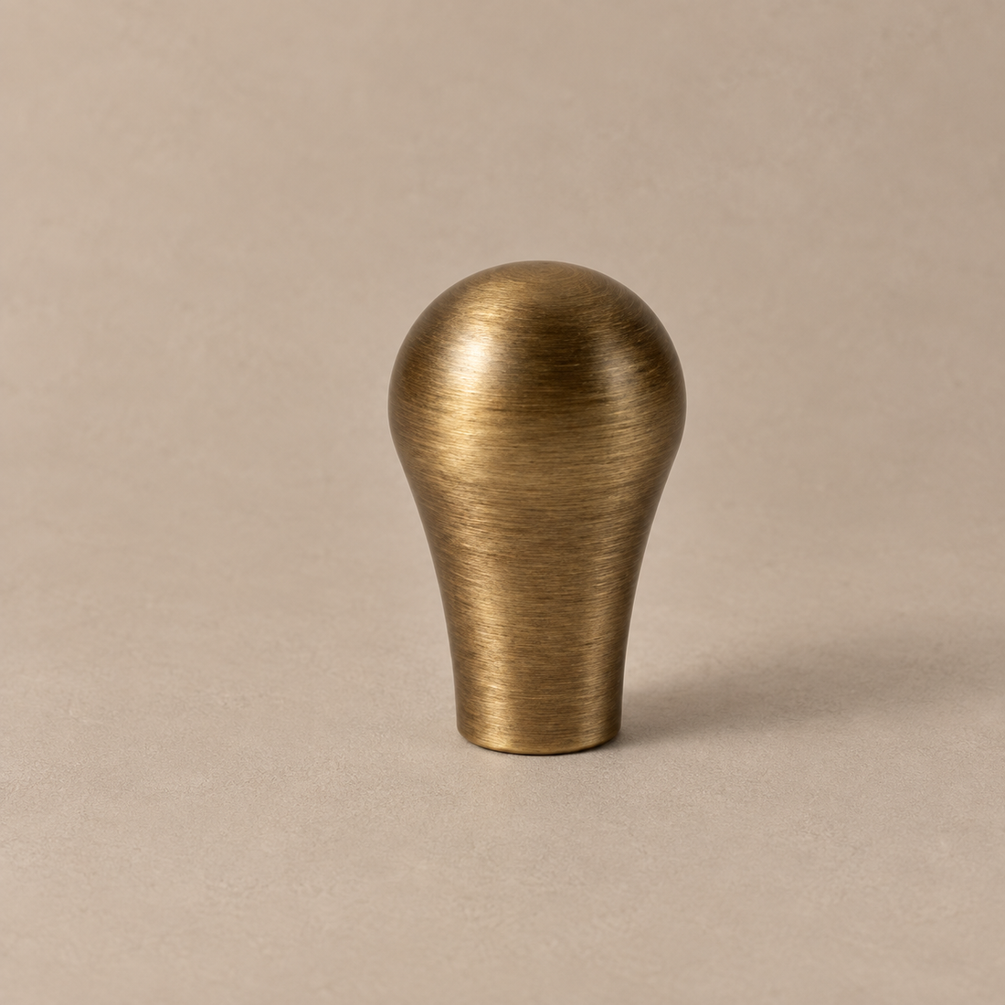 Solid Antique Brass Cabinet Handle & Knob — Antique Brass Finish on a neutral stone studio background