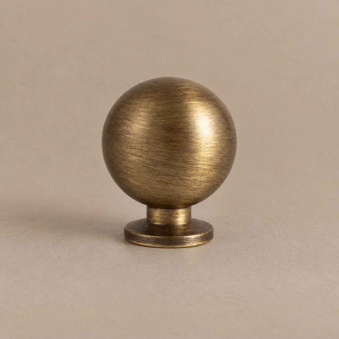 Antique Brass Round Cabinet Knobs — Retro Design on warm ivory stone