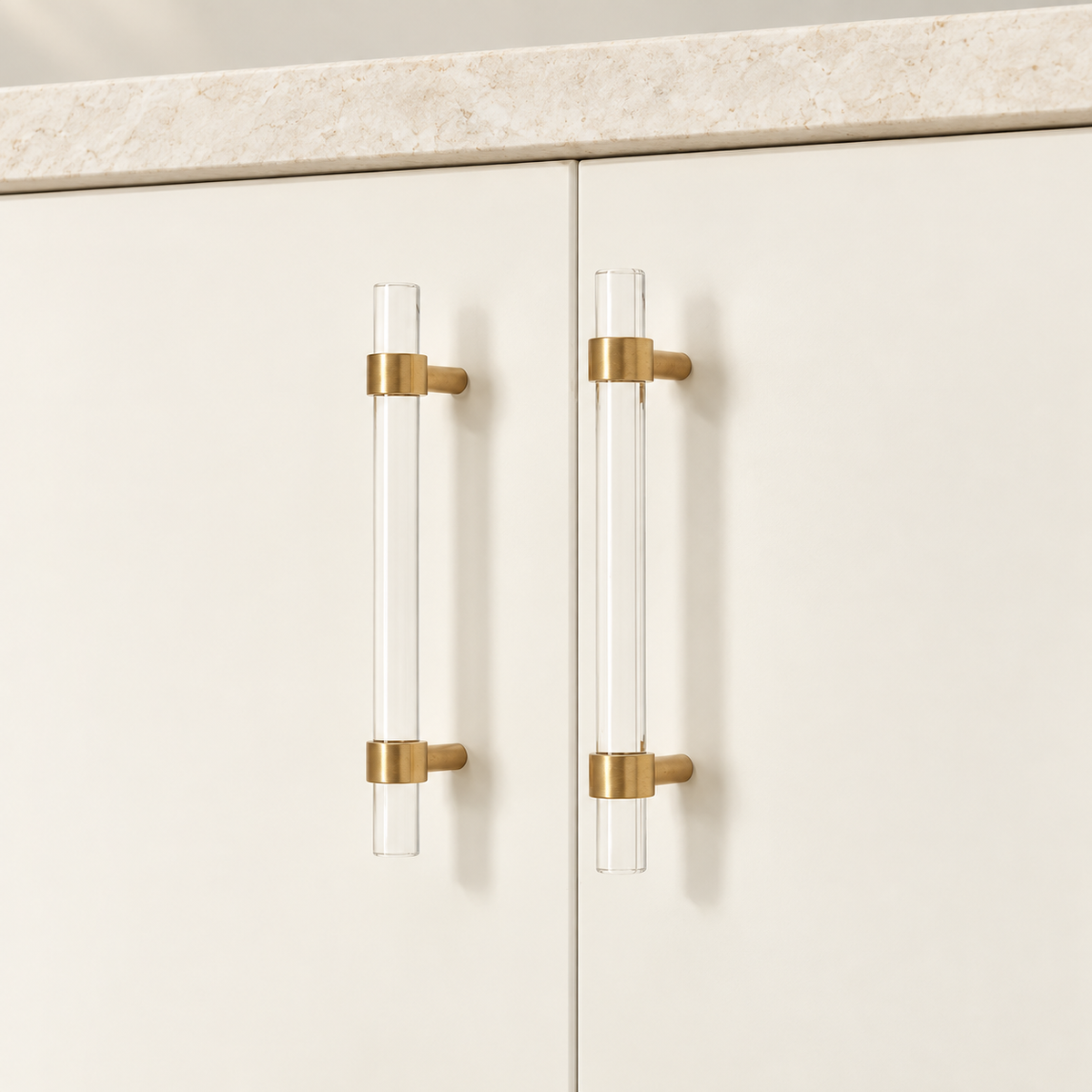 Clear Acrylic & Polished Brass Cabinet Pulls — Modern Minimalist Design — correctly mounted on warm ivory cabinetry