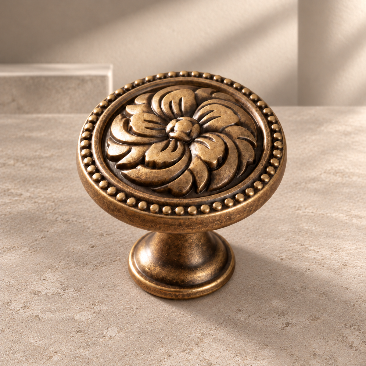 Solid Brass Floral Cabinet Knob — Antique Brass on a neutral stone studio background