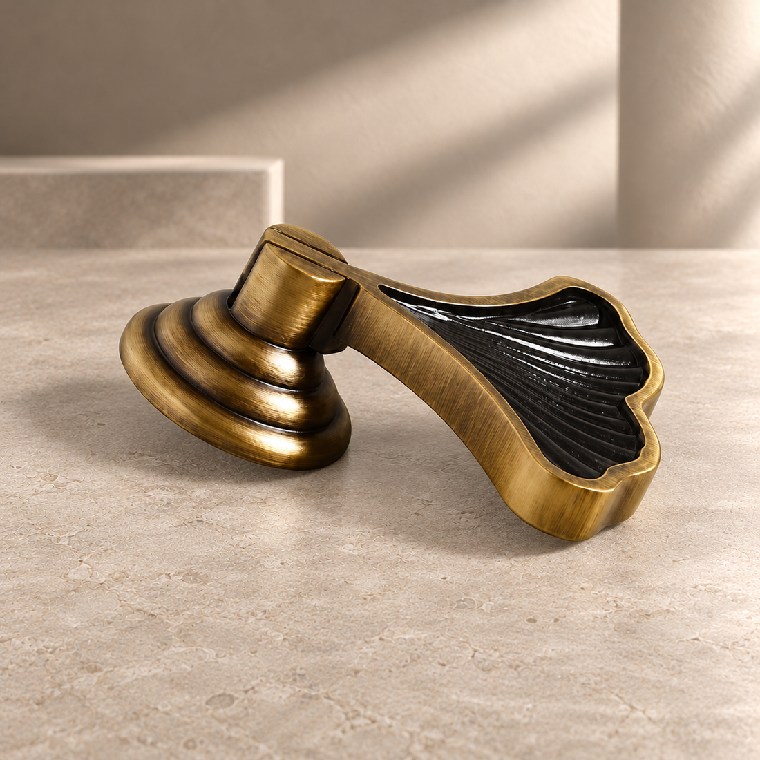 Sculpted Solid Brass Ginkgo Leaf Cabinet Knob — Antique Brass on a neutral stone studio background
