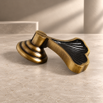 Sculpted Solid Brass Ginkgo Leaf Cabinet Knob — Antique Brass on a neutral stone studio background