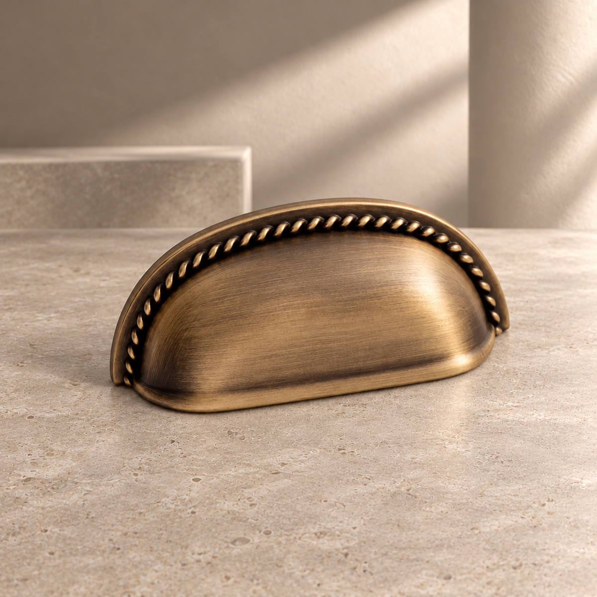 Antique Brass Shell-Shaped Thumb Cabinet Pull — Modern Design on a neutral stone studio background