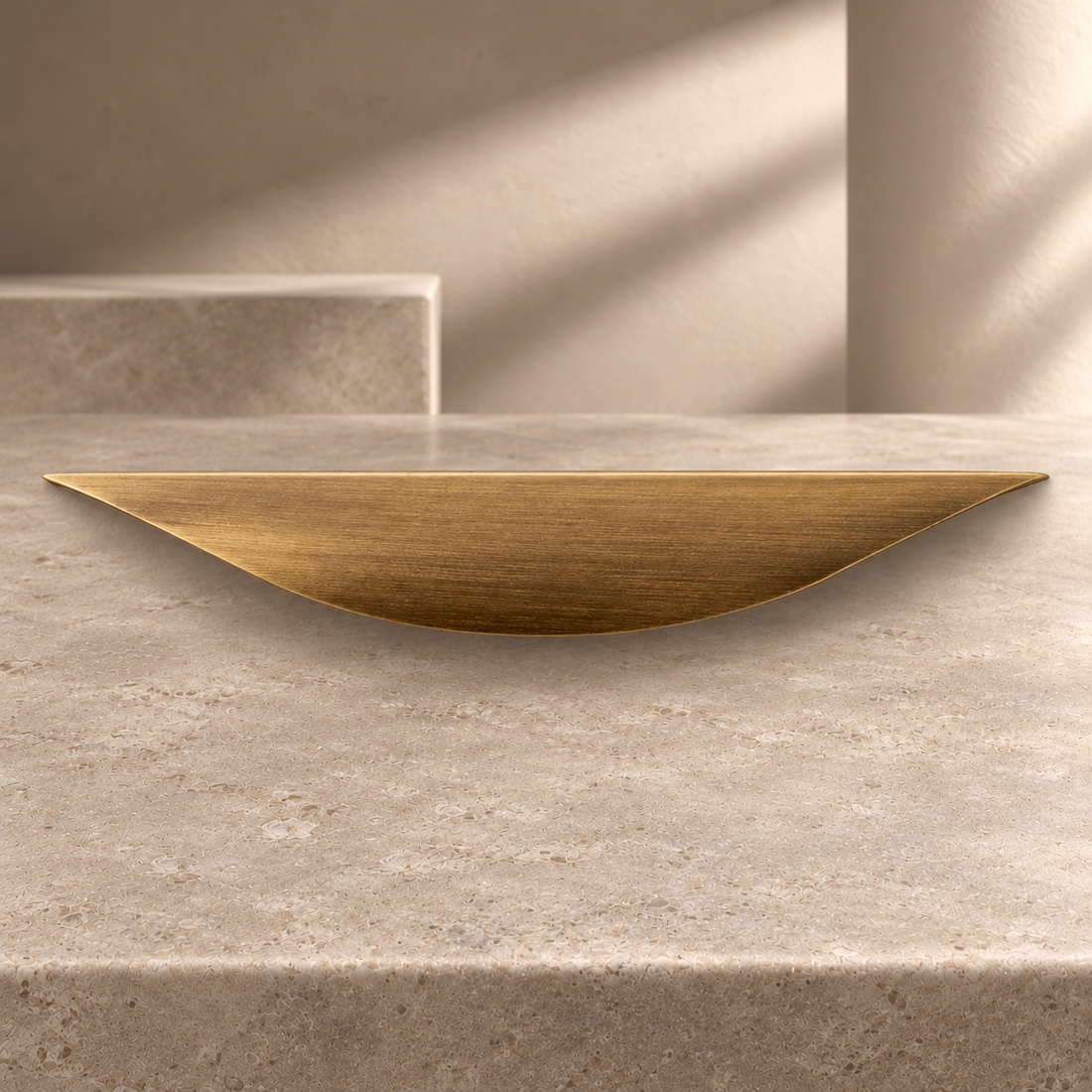 Solid Brass Leaf Cabinet Pull — Antique Brass on a neutral stone studio background