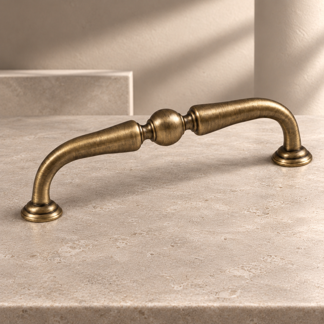 Arched Bail Cabinet Pull & Knob — Antique Brass on a neutral stone studio background