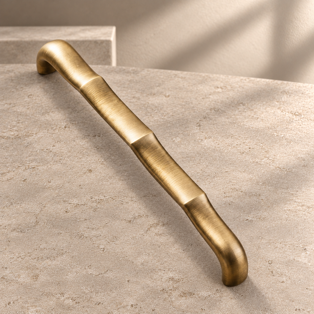Tapered Flat Bar Cabinet Pull & Knob — Antique Brass on a neutral stone studio background