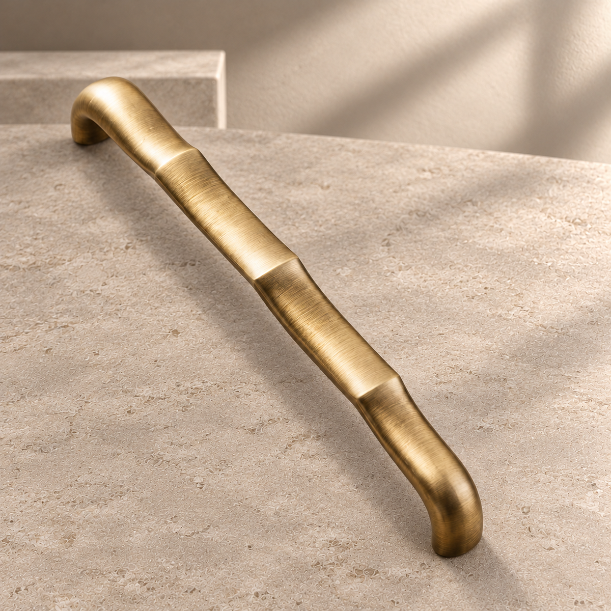 Tapered Flat Bar Cabinet Pull & Knob — Antique Brass on a neutral stone studio background