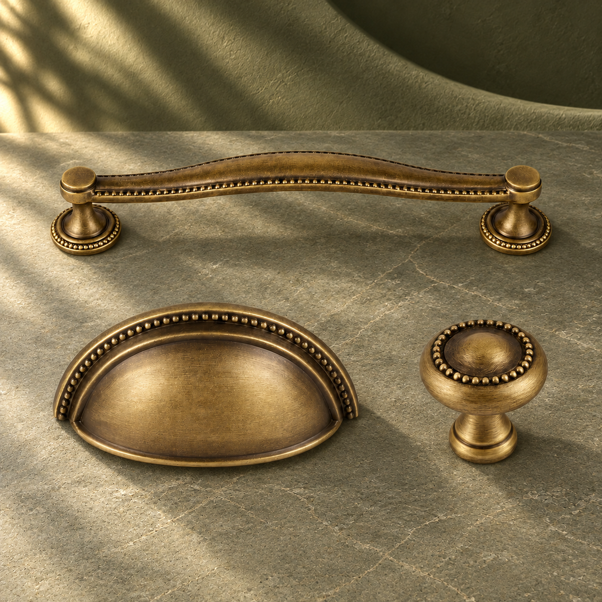 Antique Bronze Solid Brass Cabinet Knob & Cup Handle on a deep olive studio background
