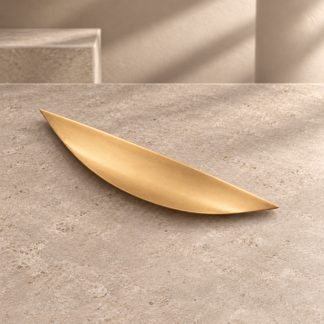 Brushed Brass Cabinet Pulls — Modern Solid Brass Hardware on a neutral stone studio background