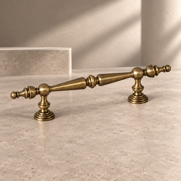 Turned Spindle Cabinet Pull & Knob — Brushed Brass on a neutral stone studio background
