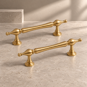 Round-Base T-Bar Cabinet Pull & Knob — Brushed Brass on a neutral stone studio background